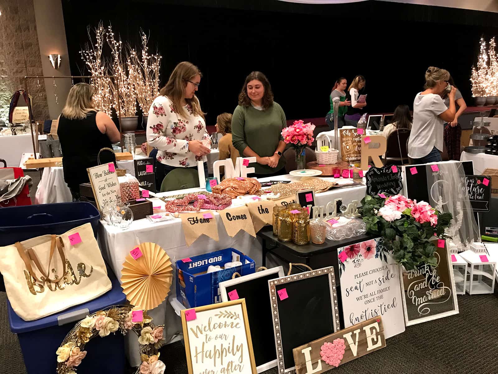 People browse and sell handmade wedding decorations and crafts at a wedding vendor booth during a bridal show in Columbus, OH.